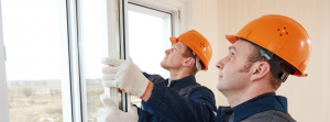 two workers installing a window